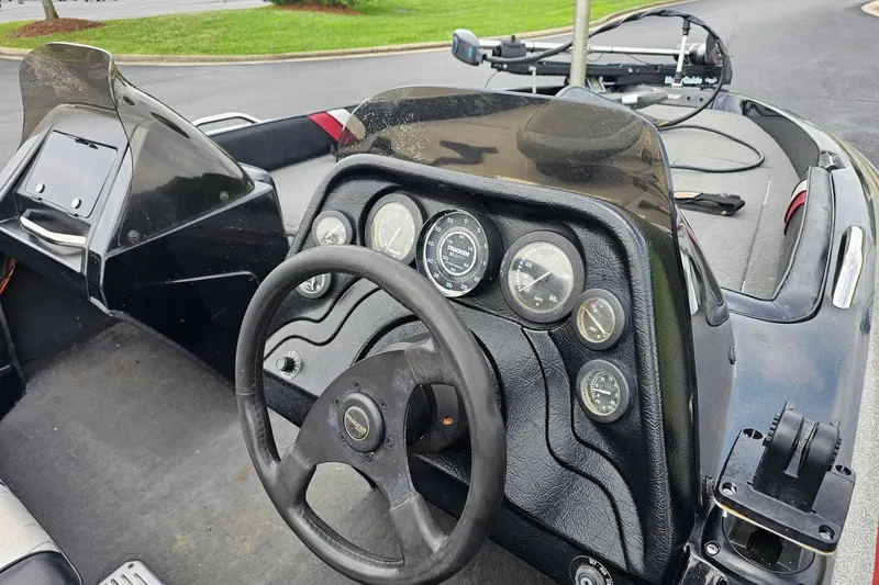 Slide: The Image of Dashboard of a 1994 Nitro 180 FS boat with steering wheel and gauges. - 9