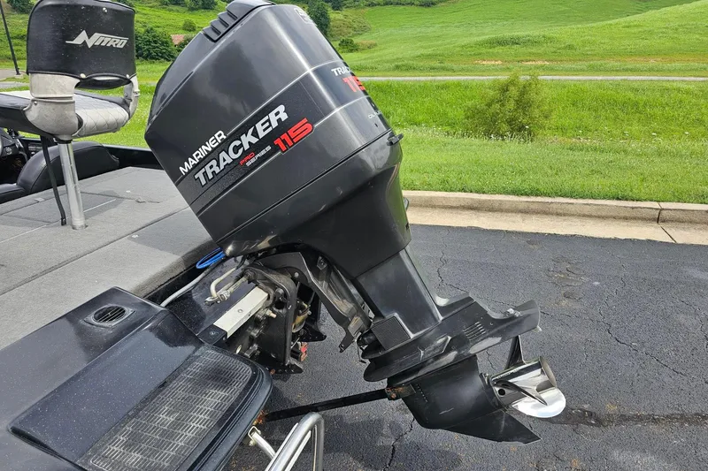 Slide: The Image of 1994 Nitro 180 FS boat with Mariner Tracker 115 outboard motor on asphalt. - 13