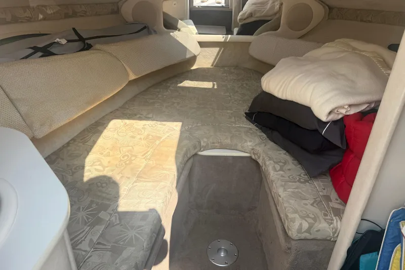 Slide: The Image of Interior cabin of a 2003 Sea Ray 225 Weekender with cushions and blankets. - 21