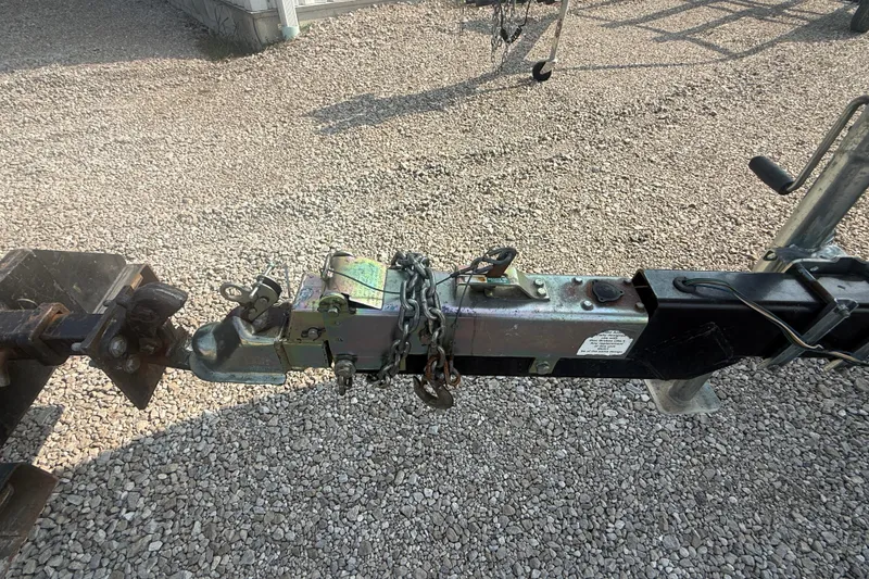 Slide: The Image of Trailer hitch of a 2003 Sea Ray 225 Weekender on gravel surface. - 7