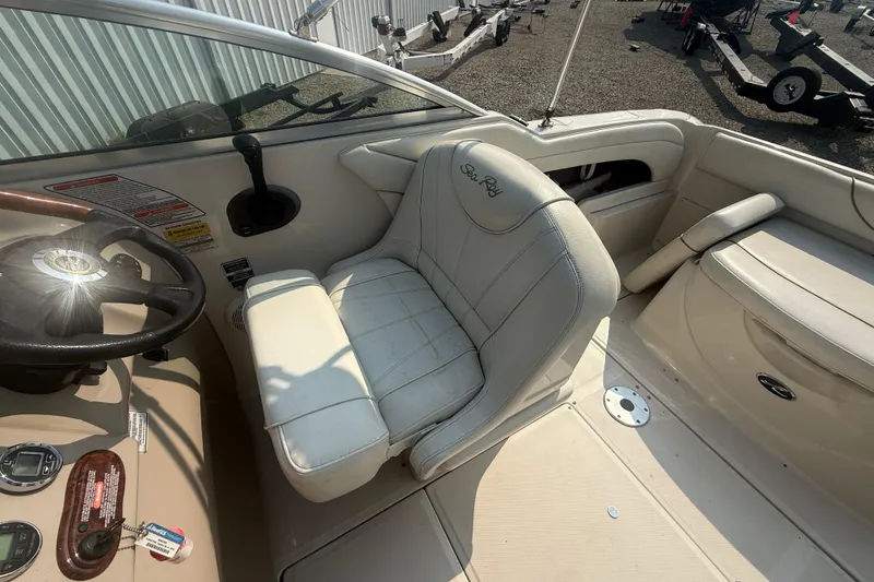 Slide: The Image of 2003 Sea Ray 225 Weekender boat interior with steering wheel and seating area. - 17