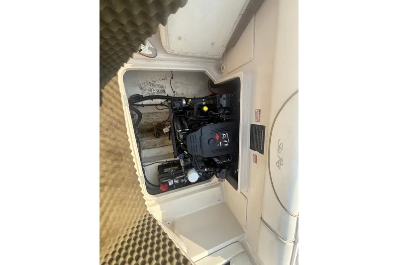 Slide: The Image of Engine compartment of a 2003 Sea Ray 225 Weekender boat, showcasing the motor. - 16