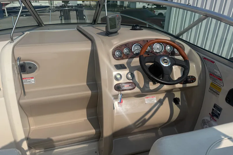 Slide: The Image of 2003 Sea Ray 225 Weekender boat dashboard with steering wheel and instrument panel. - 12