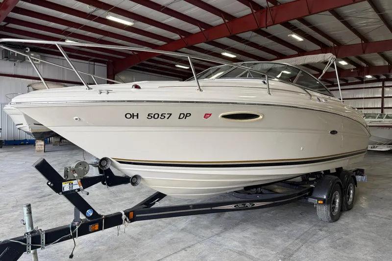 Slide: The Image of 2003 Sea Ray 225 Weekender boat on trailer in indoor storage facility. - 2