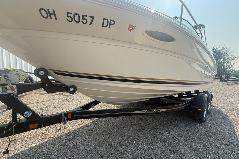Slide: The Image of 2003 Sea Ray 225 Weekender boat on trailer, side view, with registration number visible. - 8