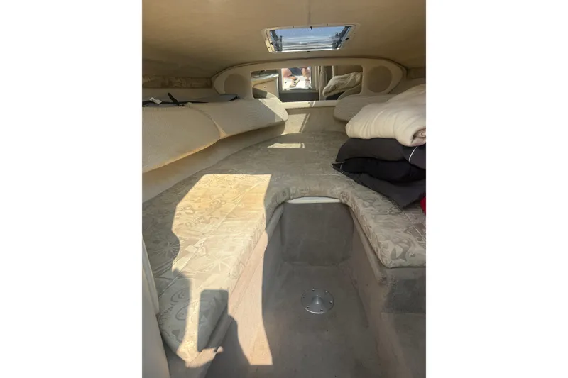 Slide: The Image of Interior cabin of a 2003 Sea Ray 225 Weekender boat, featuring cozy sleeping area. - 22