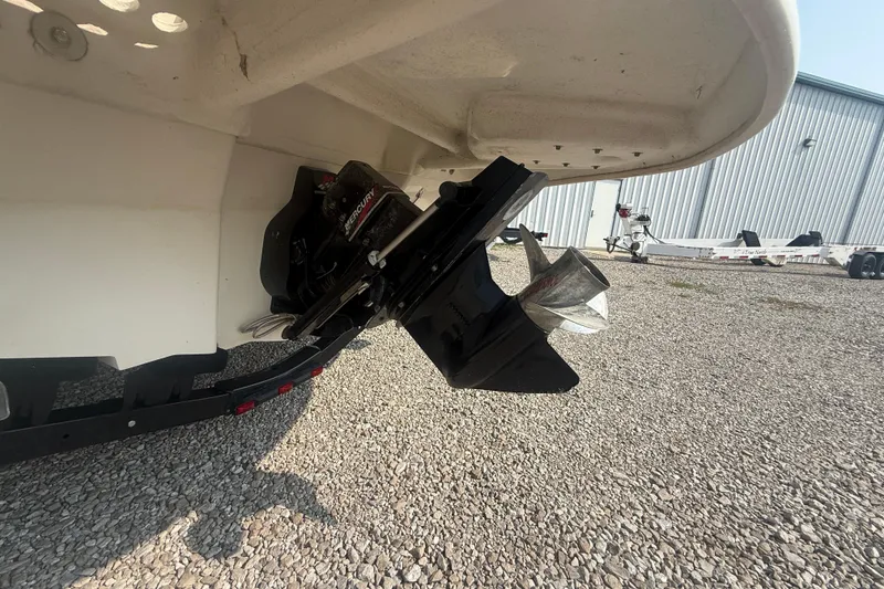 Slide: The Image of 2003 Sea Ray 225 Weekender boat with Mercury outboard motor on gravel surface. - 9