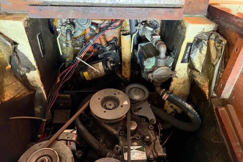 Slide: The Image of Engine compartment of a 1986 Pearson 33 sailboat, showing mechanical components and wiring. - 41