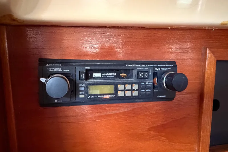 Slide: The Image of 1986 Pearson 33 boat stereo system with cassette player and wooden paneling. - 19