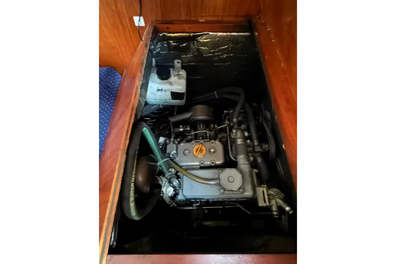 Slide: The Image of Engine compartment of a 1986 Pearson 33 sailboat, showcasing mechanical components. - 39