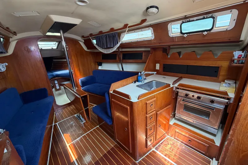 Slide: The Image of Interior of a 1986 Pearson 33 sailboat with wood finish and compact kitchen. - 1