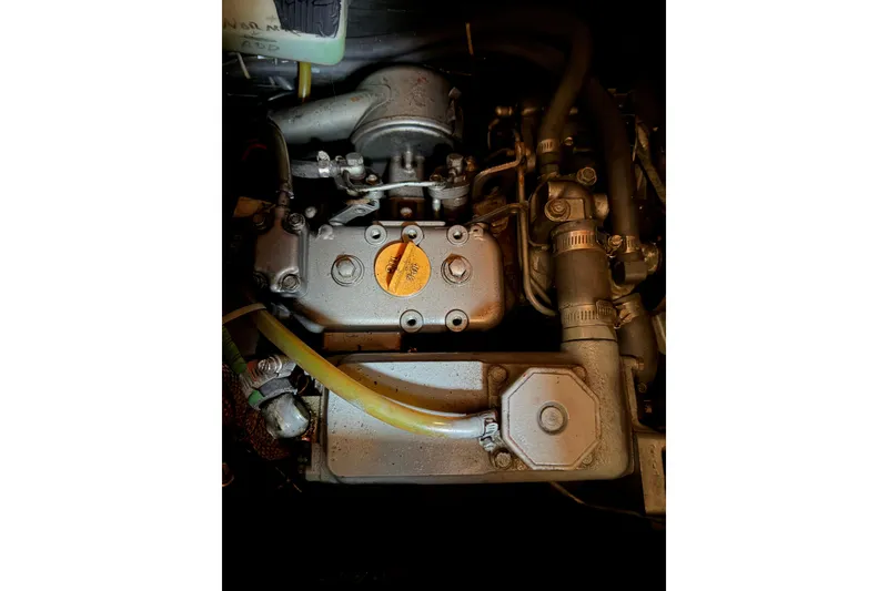 Slide: The Image of Engine compartment of a 1986 Pearson 33 sailboat, showcasing mechanical components and hoses. - 40