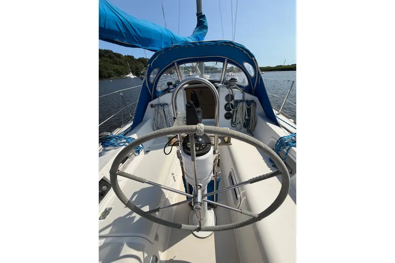 Slide: The Image of Cockpit of a 1986 Pearson 33 sailboat with blue canopy and steering wheel. - 20
