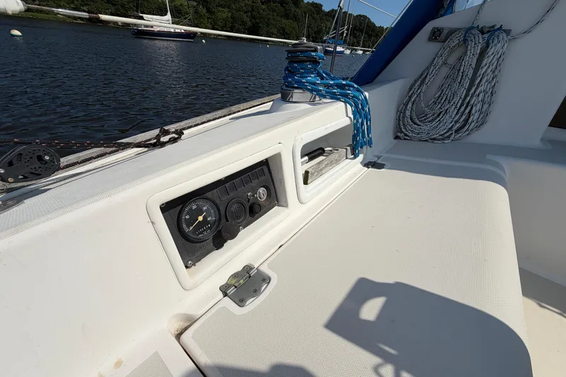 Slide: The Image of Cockpit of 1986 Pearson 33 sailboat with control panel and coiled ropes. - 23