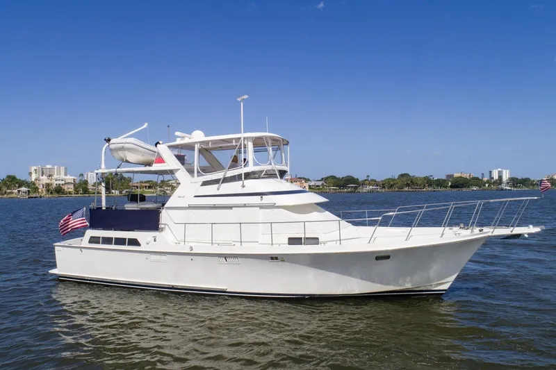 The Image of 1988 Tollycraft 44 Cockpit Motor Yacht on calm water under clear blue sky. - 1