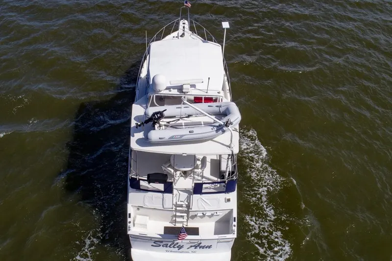 Slide: The Image of 1988 Tollycraft 44 Cockpit Motor Yacht cruising on open water, aerial view. - 4