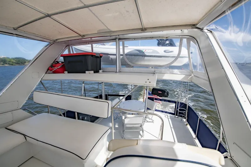 Slide: The Image of 1988 Tollycraft 44 Cockpit Motor Yacht interior with seating and water view. - 63