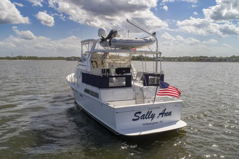 Slide: The Image of 1988 Tollycraft 44 Cockpit Motor Yacht on water, American flag, Wilmington, NC. - 5