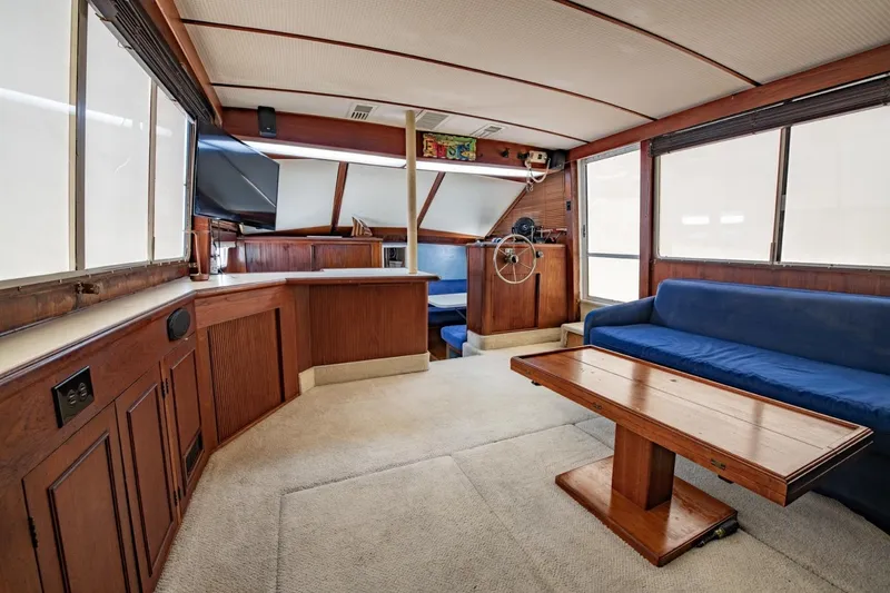 Slide: The Image of Interior of 1988 Tollycraft 44 Cockpit Motor Yacht with wood accents and blue seating. - 12