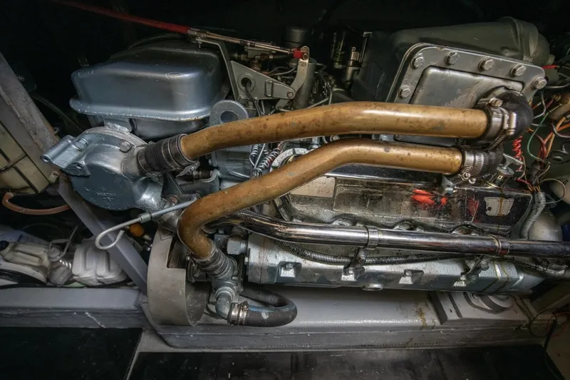 Slide: The Image of Engine compartment of a 1988 Tollycraft 44 Cockpit Motor Yacht, showcasing mechanical components. - 65