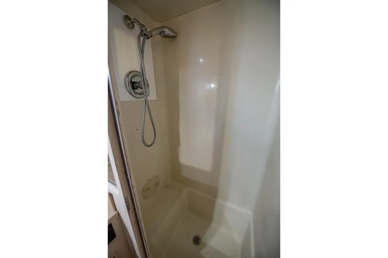 Slide: The Image of Shower area in 1988 Tollycraft 44 Cockpit Motor Yacht, featuring handheld showerhead. - 32