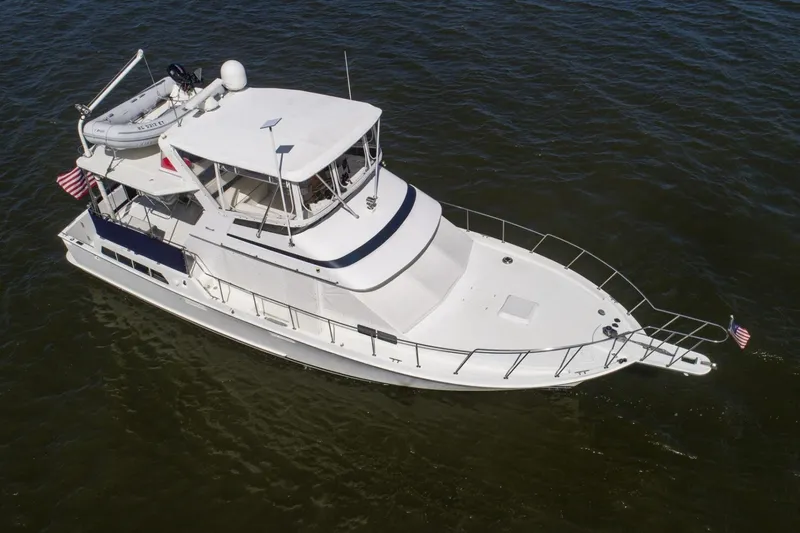 Slide: The Image of 1988 Tollycraft 44 Cockpit Motor Yacht cruising on open water. - 8