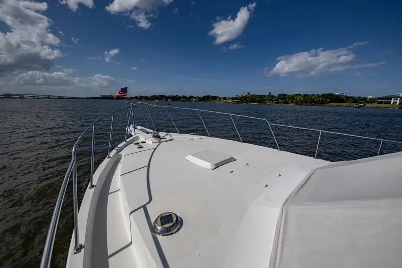 Slide: The Image of 1988 Tollycraft 44 Cockpit Motor Yacht cruising on a sunny day with clear skies. - 58