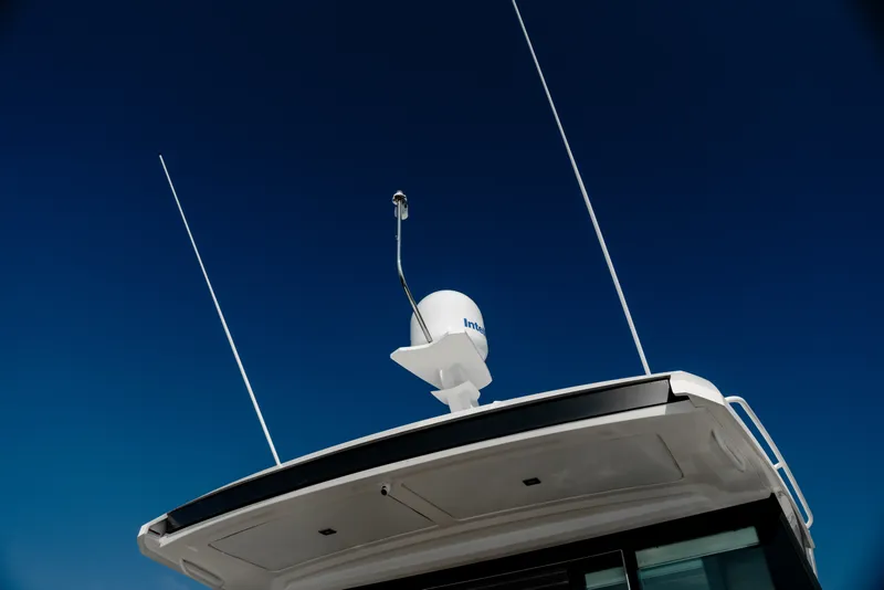 Slide: The Image of Tiara Yachts C49 Coupe 2020 with radar equipment against a clear blue sky. - 52