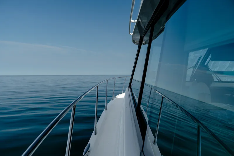 Slide: The Image of 2020 Tiara Yachts C49 Coupe cruising on calm ocean waters. - 38
