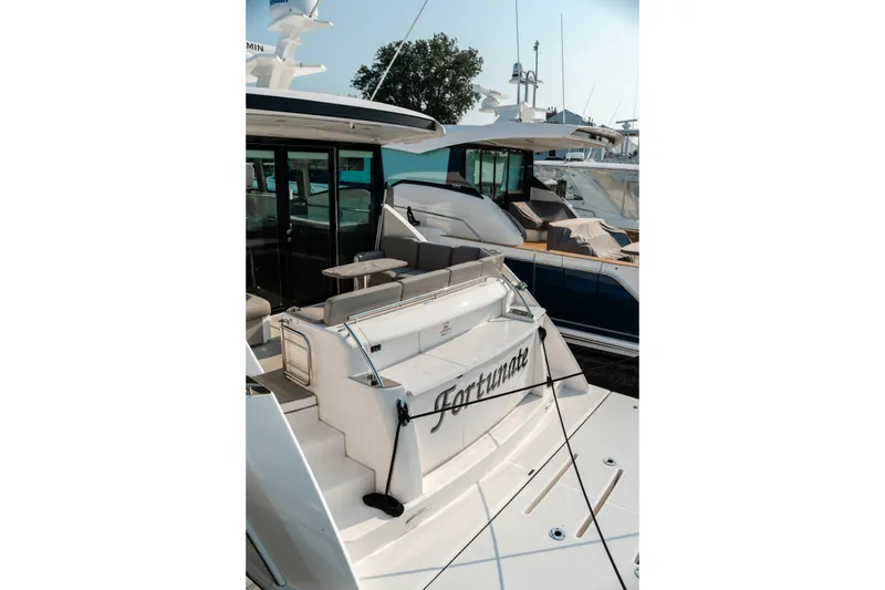 Slide: The Image of 2020 Tiara Yachts C49 Coupe docked, featuring sleek design and luxury amenities. - 13