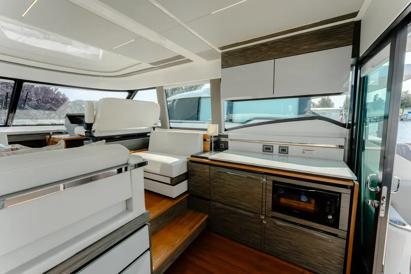 Slide: The Image of Luxurious interior of 2020 Tiara Yachts C49 Coupe with modern kitchen and seating area. - 20