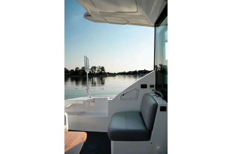 Slide: The Image of 2020 Tiara Yachts C49 Coupe interior with serene water view. - 18