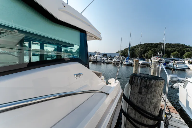 Slide: The Image of 2020 Tiara Yachts C49 Coupe docked at a marina, showcasing sleek design and luxury. - 11