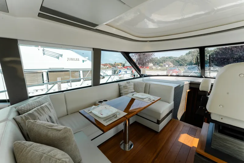 Slide: The Image of Luxurious interior of 2020 Tiara Yachts C49 Coupe with elegant dining area and panoramic windows. - 22