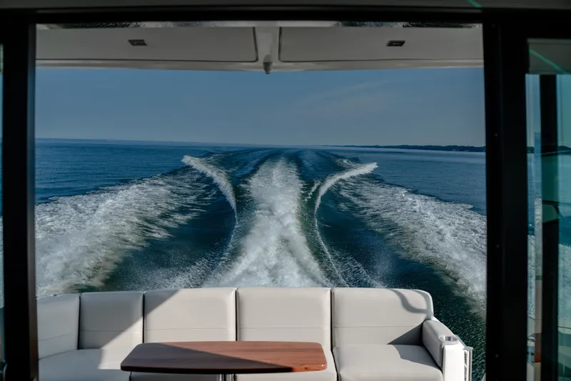 Slide: The Image of 2020 Tiara Yachts C49 Coupe cruising, view from interior with ocean wake. - 16
