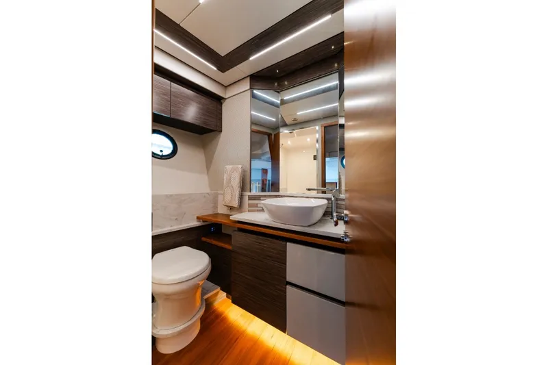 Slide: The Image of Luxurious bathroom interior of 2020 Tiara Yachts C49 Coupe with modern fixtures and wood accents. - 30