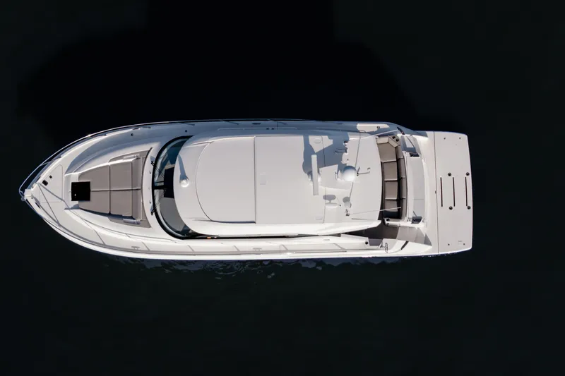 Slide: The Image of Overhead view of 2020 Tiara Yachts C49 Coupe, sleek design on dark water. - 6