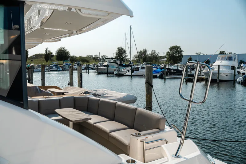Slide: The Image of 2020 Tiara Yachts C49 Coupe docked at marina with luxurious seating area. - 17
