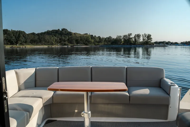 Slide: The Image of 2020 Tiara Yachts C49 Coupe's elegant deck with seating and scenic water view. - 15