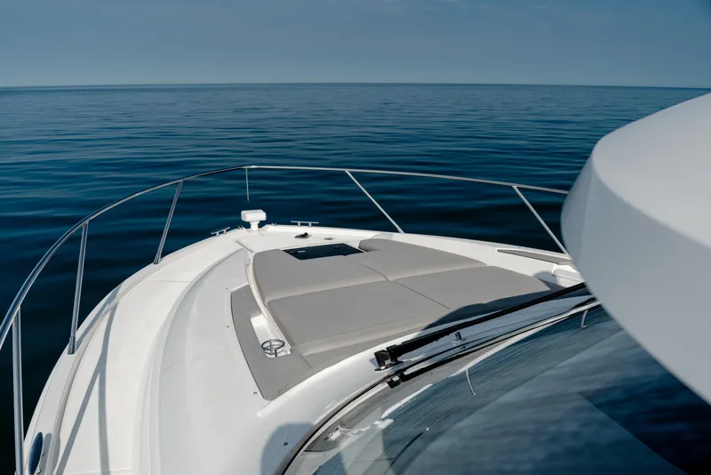 Slide: The Image of 2020 Tiara Yachts C49 Coupe cruising on calm blue waters. - 40