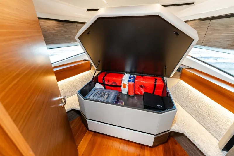 Slide: The Image of 2020 Tiara Yachts C49 Coupe interior storage compartment with red bags and supplies. - 33