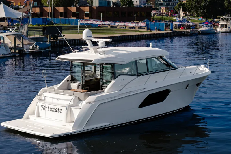 Slide: The Image of 2020 Tiara Yachts C49 Coupe on water, docked at marina. - 5