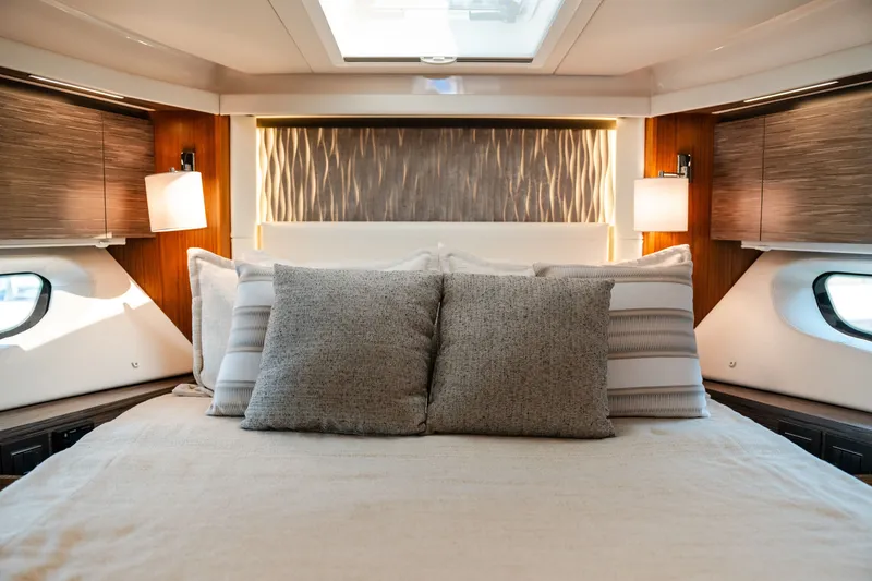 Slide: The Image of Luxurious bedroom interior of 2020 Tiara Yachts C49 Coupe with elegant lighting and plush bedding. - 32