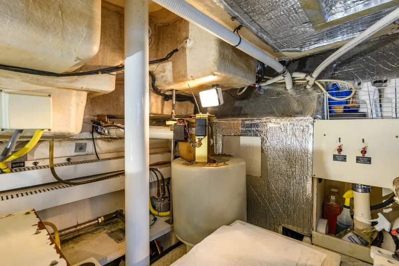 Slide: The Image of Engine room of 2003 Cruisers 5470 Express yacht, featuring equipment and wiring. - 40