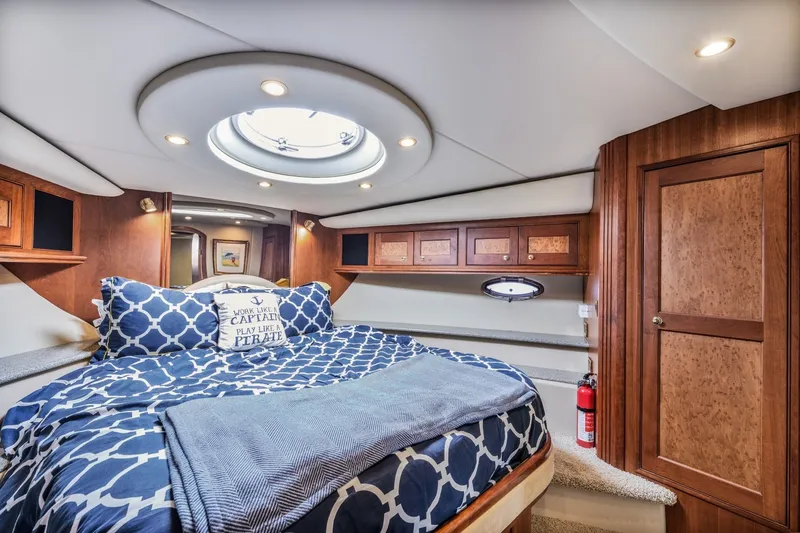 Slide: The Image of Luxurious cabin interior of 2003 Cruisers 5470 Express yacht with nautical bedding. - 49