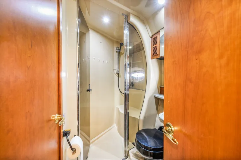 Slide: The Image of Luxurious bathroom interior of 2003 Cruisers 5470 Express yacht with shower and wooden accents. - 51