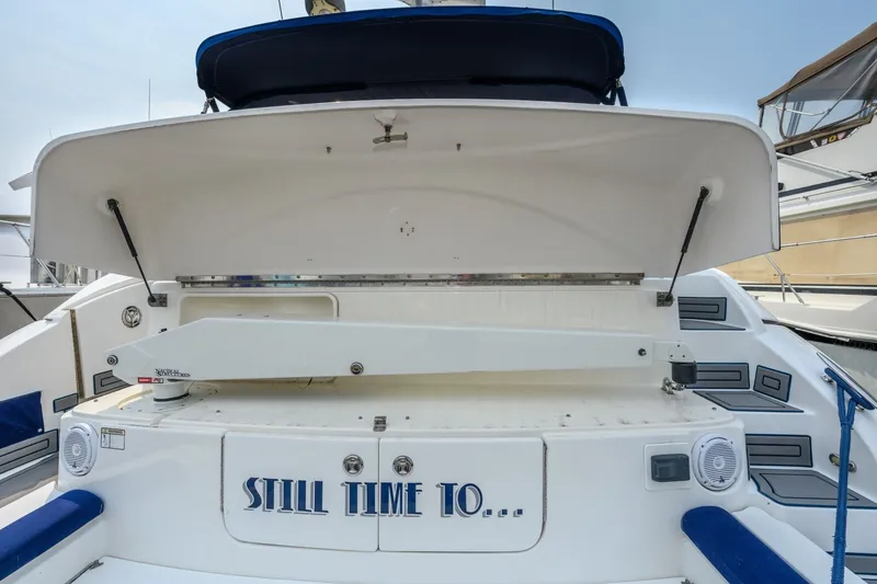 Slide: The Image of 2003 Cruisers 5470 Express yacht stern with open storage and "Still Time To..." text. - 22