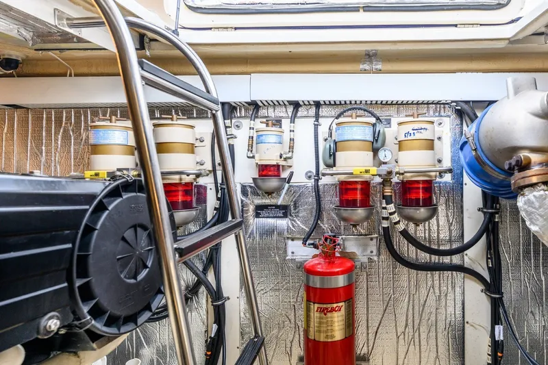 Slide: The Image of Engine room of 2003 Cruisers 5470 Express with fuel filters and fire extinguisher. - 35