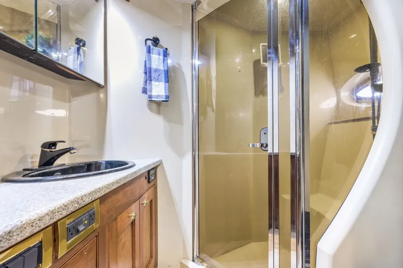 Slide: The Image of Luxurious bathroom in 2003 Cruisers 5470 Express yacht with shower and sink. - 46