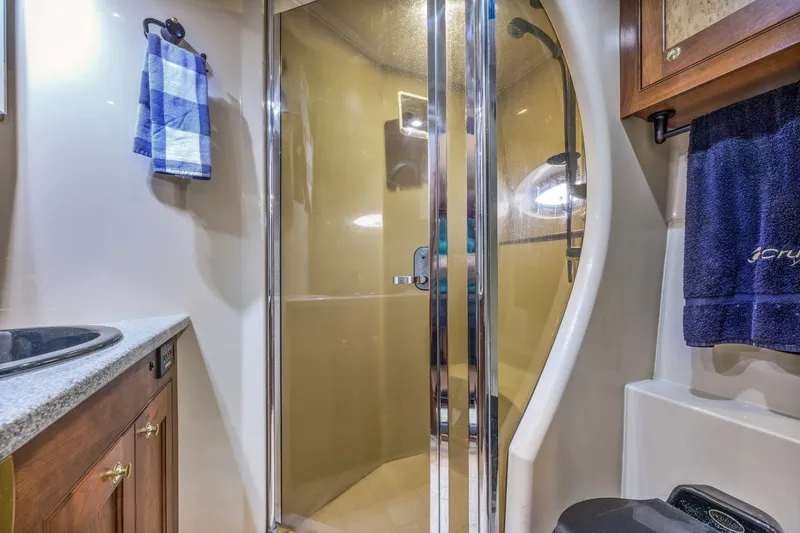 Slide: The Image of Luxurious bathroom in 2003 Cruisers 5470 Express yacht with glass shower and elegant fixtures. - 45